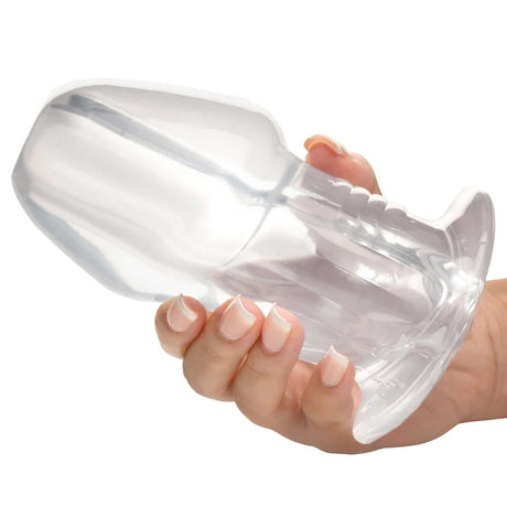 Master Series Dicked Clear Hollow Anal Plug XLarge held in hand, showcasing its transparent design and hollow feature.