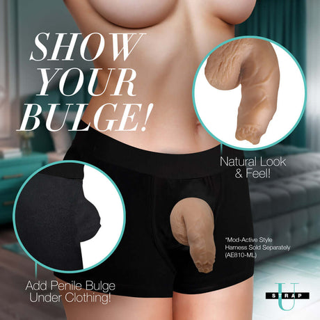 Strap U 5.1 inch Uncut Silicone Packer Dildo Medium in a pair of black shorts showing a realistic bulge.