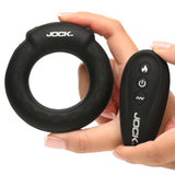 JOCK Rumbler 1.8 inch Vibrating & Warming C-Ring with remote control in hand, showcasing its sleek design.