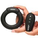 JOCK Rumbler 2 inch Vibrating & Warming C-Ring and remote control in hand for enhanced stimulation