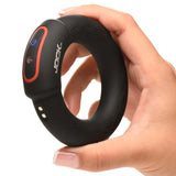 Hand holding the JOCK Rumbler 2 inch Vibrating & Warming C-Ring, showcasing its sleek design and remote control features.
