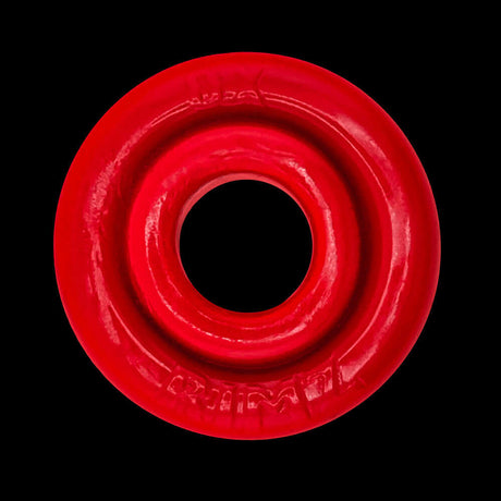 Oxballs Rimz Single Ring Red displayed on a black background, highlighting its flexible design and vibrant color.
