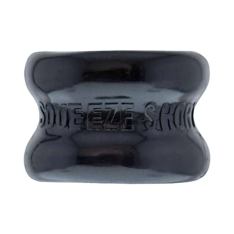 Oxballs Squeeze Short Ballstretcher Black shown from above, highlighting its compact design and hourglass shape.