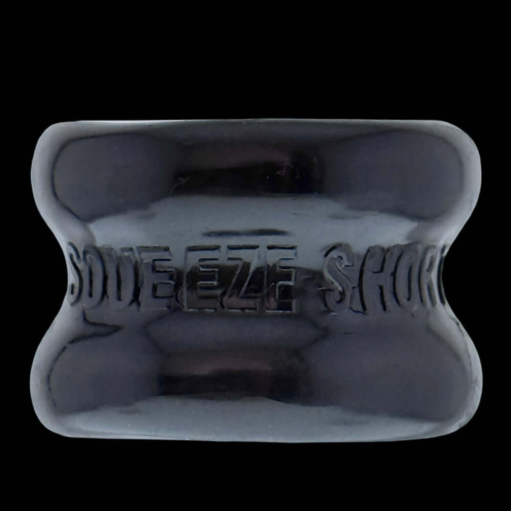 Oxballs Squeeze Short Ballstretcher Black, a compact hourglass-shaped ball stretcher for secure stretching.
