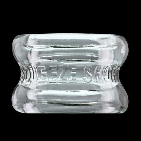 Oxballs Squeeze Short Ballstretcher Clear, featuring a compact hourglass design for comfortable use.