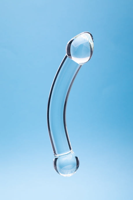 Clarity Celestial Purity Glass Dildo showcased against a light blue background, highlighting its elegant design.