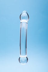Clarity Celestial Purity Glass Dildo against a blue background, showcasing its elegant design and craftsmanship.