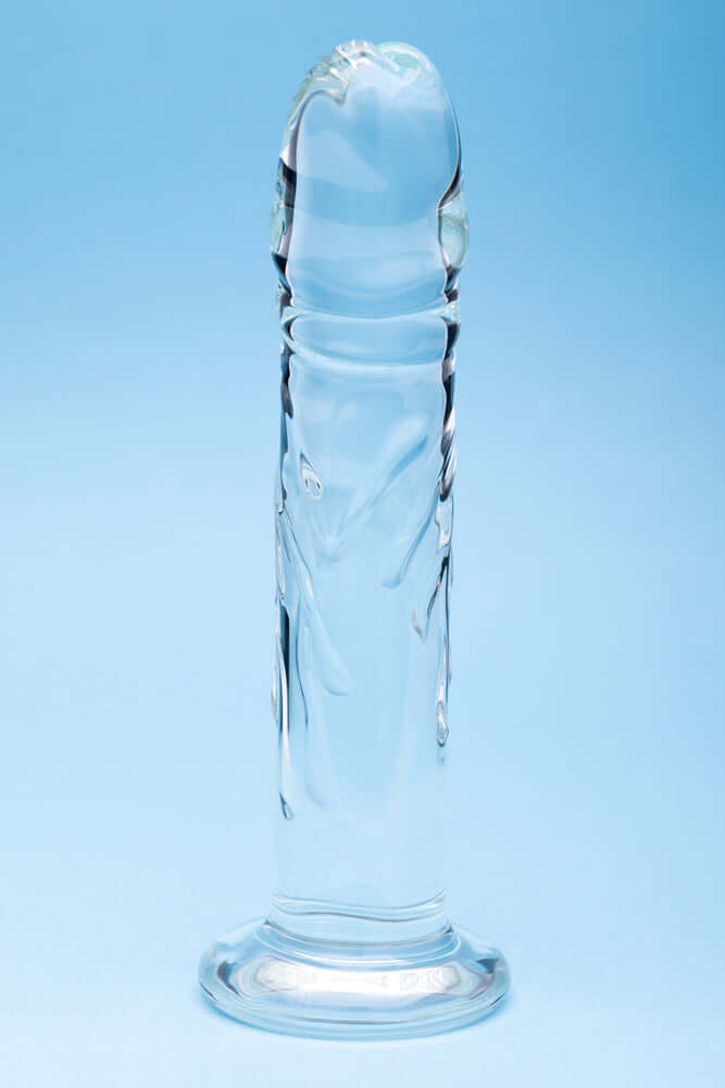 Clarity Seraphic Rapture Glass Dildo showcasing elegant design and smooth surface on a blue background.