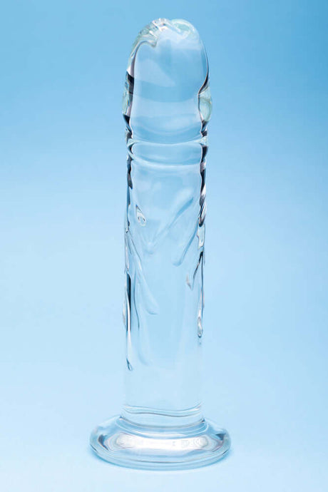 Clarity Seraphic Rapture Glass Dildo showcasing elegant design and smooth surface on a blue background.