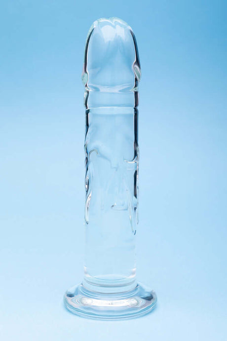 Clarity Seraphic Rapture Glass Dildo showcased against a blue background, highlighting its sleek design and craftsmanship.