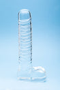 Clarity Seraphic Opus Glass Dildo on a blue background, showcasing its elegant design and handblown craftsmanship.