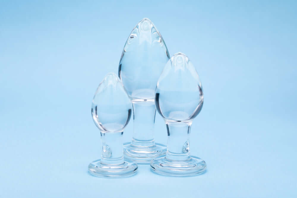 Clarity Utopian Trinity Glass Plug Set featuring three handcrafted glass plugs on a blue background.