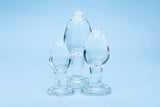 Clarity Utopian Trinity Glass Plug Set featuring three handcrafted glass plugs on a blue background.