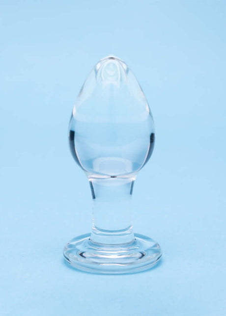 Clarity Utopian Trinity Glass Plug Set - clear glass butt plug with a refined design on a blue background.