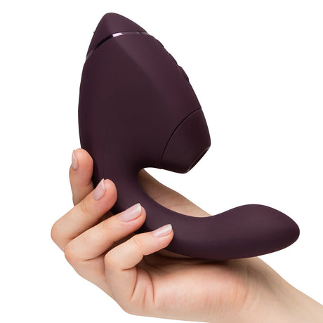 Womanizer Next Duo Massager Dark Purple held in hand showcasing its ergonomic design and advanced features.