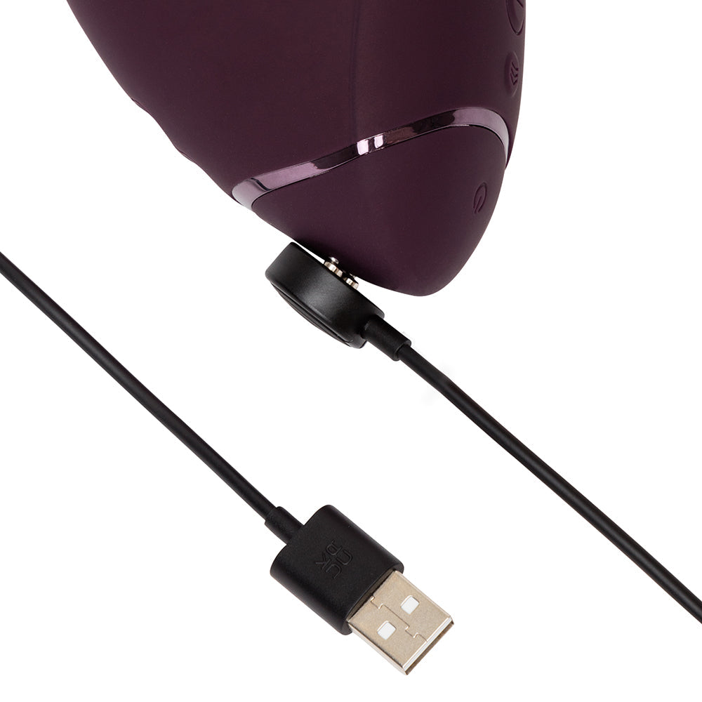 Womanizer Next Duo Massager Dark Purple with USB charging cable attached for easy power.