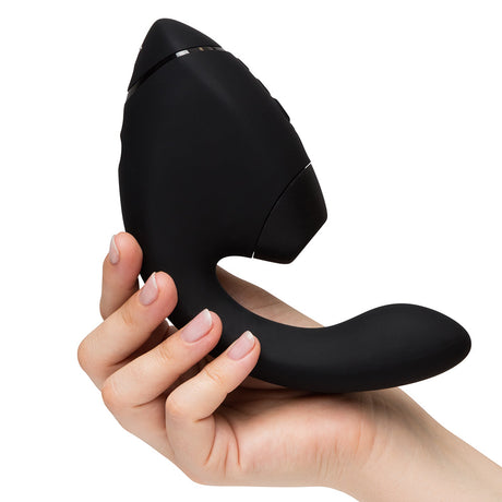 Womanizer Next Duo Massager Black held in hand, showcasing its sleek design and dual stimulation features.