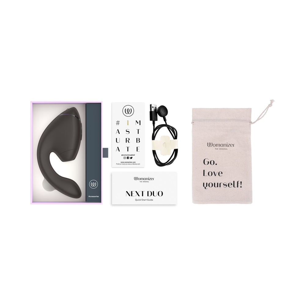 Womanizer Next Duo Massager Black packaging with accessories and guide for pleasure enhancement.