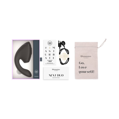 Womanizer Next Duo Massager Black packaging with accessories and guide for pleasure enhancement.