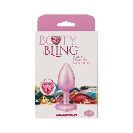 Booty Bling Heart Diamond Jeweled Metal Plug Pink Small in packaging with colorful background.