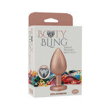 Booty Bling Heart Diamond Jeweled Metal Plug Gold Large packaging with decoration and colorful gems in the background.
