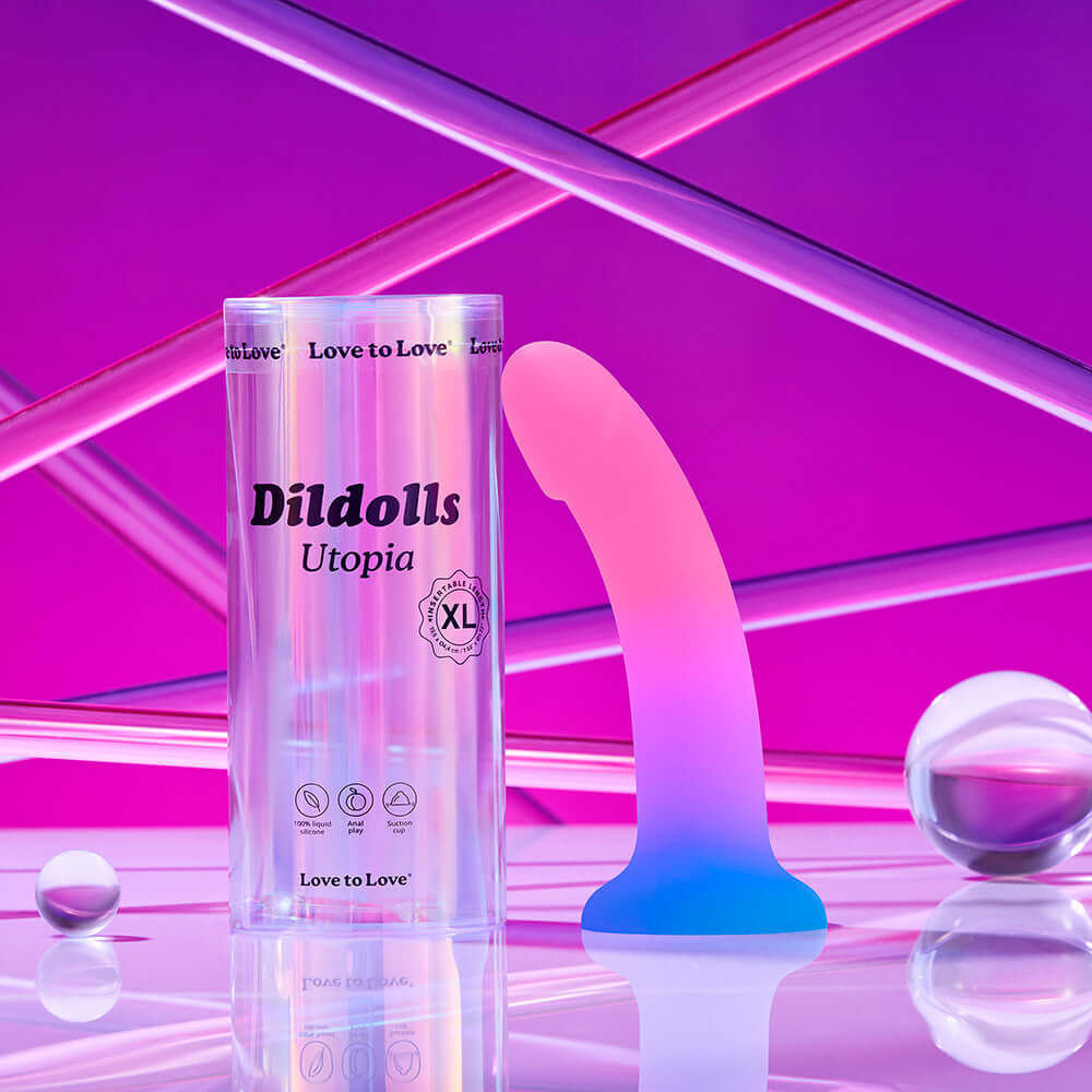 Love to Love Dildolls Utopia XLarge silicone dildo with packaging against a vibrant background.