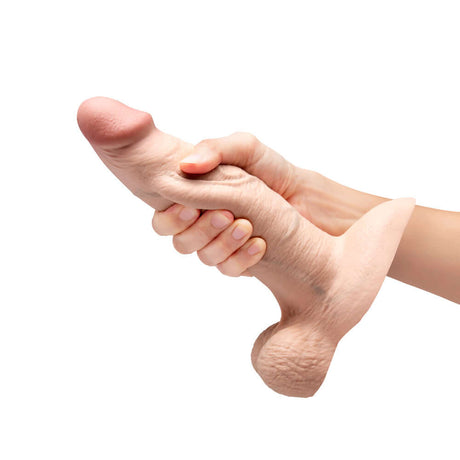 b-Vibe Slipskin Realistic Silicone Dildo 8 inch Girthy Cream being held in hand, showcasing its lifelike texture and design.