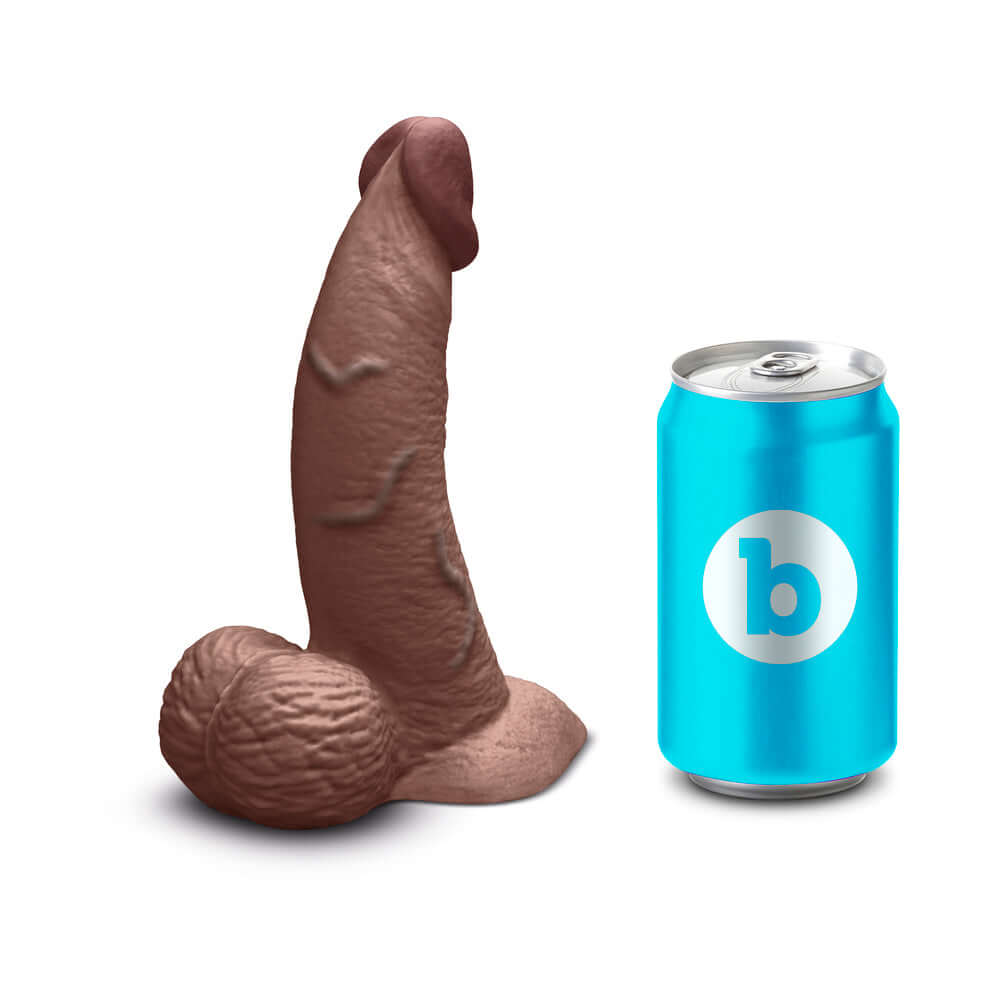 b-Vibe Slipskin Realistic Silicone Dildo 6.5 inch Curved Brown next to a soda can for size comparison