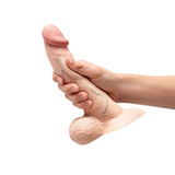 b-Vibe Slipskin Realistic Silicone Dildo 8 inch Curved Cream held in hand to showcase realistic design and texture.