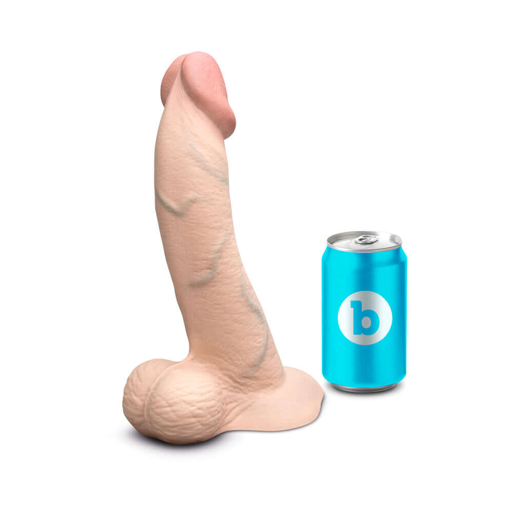 b-Vibe Slipskin Realistic Silicone Dildo 10 inch Curved Cream next to a blue soda can for size comparison.