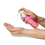 Eye of Love Pheromone Body Oil 4 Oz Pump Sunny Daze being dispensed onto a hand.