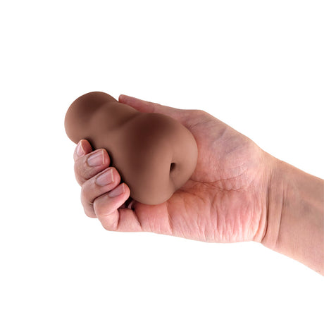 Pocket Pals Anal Stroker Brown held in a hand, showcasing its compact and lifelike design for intense pleasure.