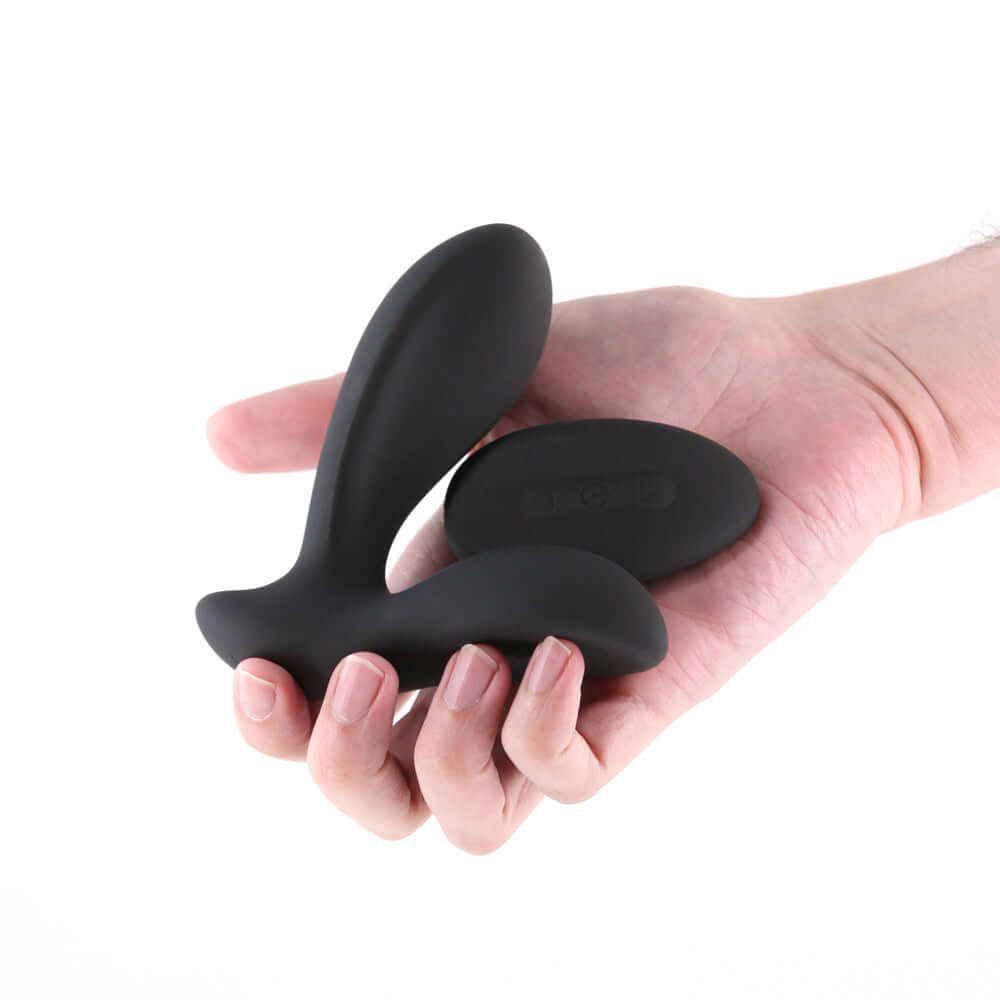 Renegade Rain Prostate Massager with Remote Control Black held in a hand, showcasing its sleek silicone design.