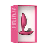 We-Vibe Ditto Plus Remote Control Vibrating Anal Plug Pink in its packaging, showcasing its sleek design and vibrant color.