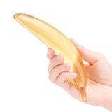 Glas Banana Joy 7 inches Glass Dildo being held in a hand, showcasing its whimsical banana shape and smooth finish.