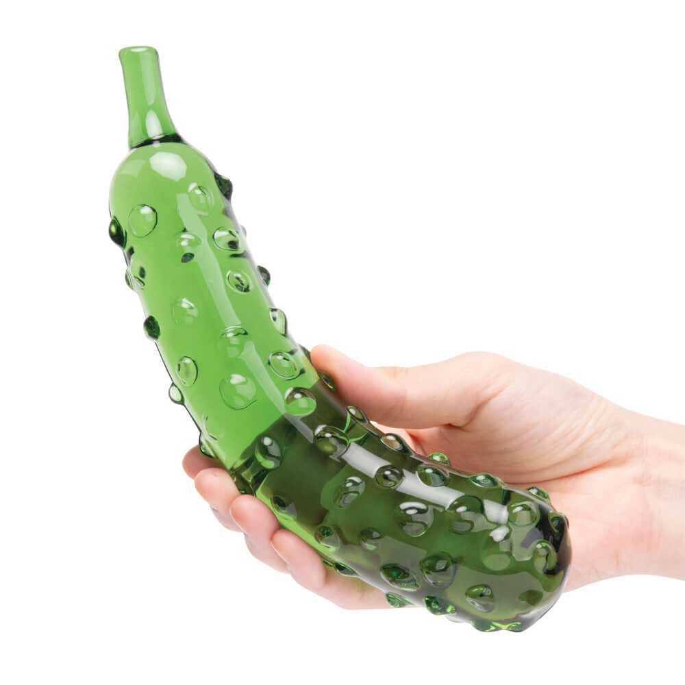Glas Caressing Cucumber 8.25 inches Glass Dildo held in hand, showcasing its textured surface and realistic design.
