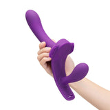Together Lock-In Dual-Ended Vibrating Strap-on & Harness Set in purple being held with one hand.