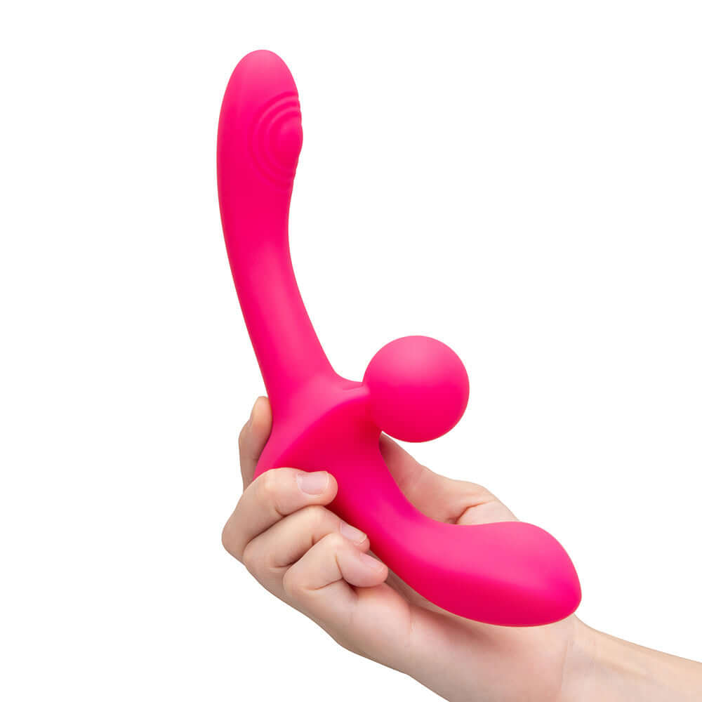 Together Double Tap Dual-Ended Vibrating Strapless Strap-on held in hand, showcasing its sleek design and vibrant color.