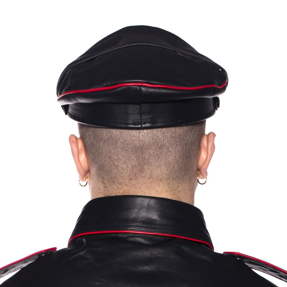 Back view of Prowler Red Military Cap Black Red 59 cm Large worn with leather attire.