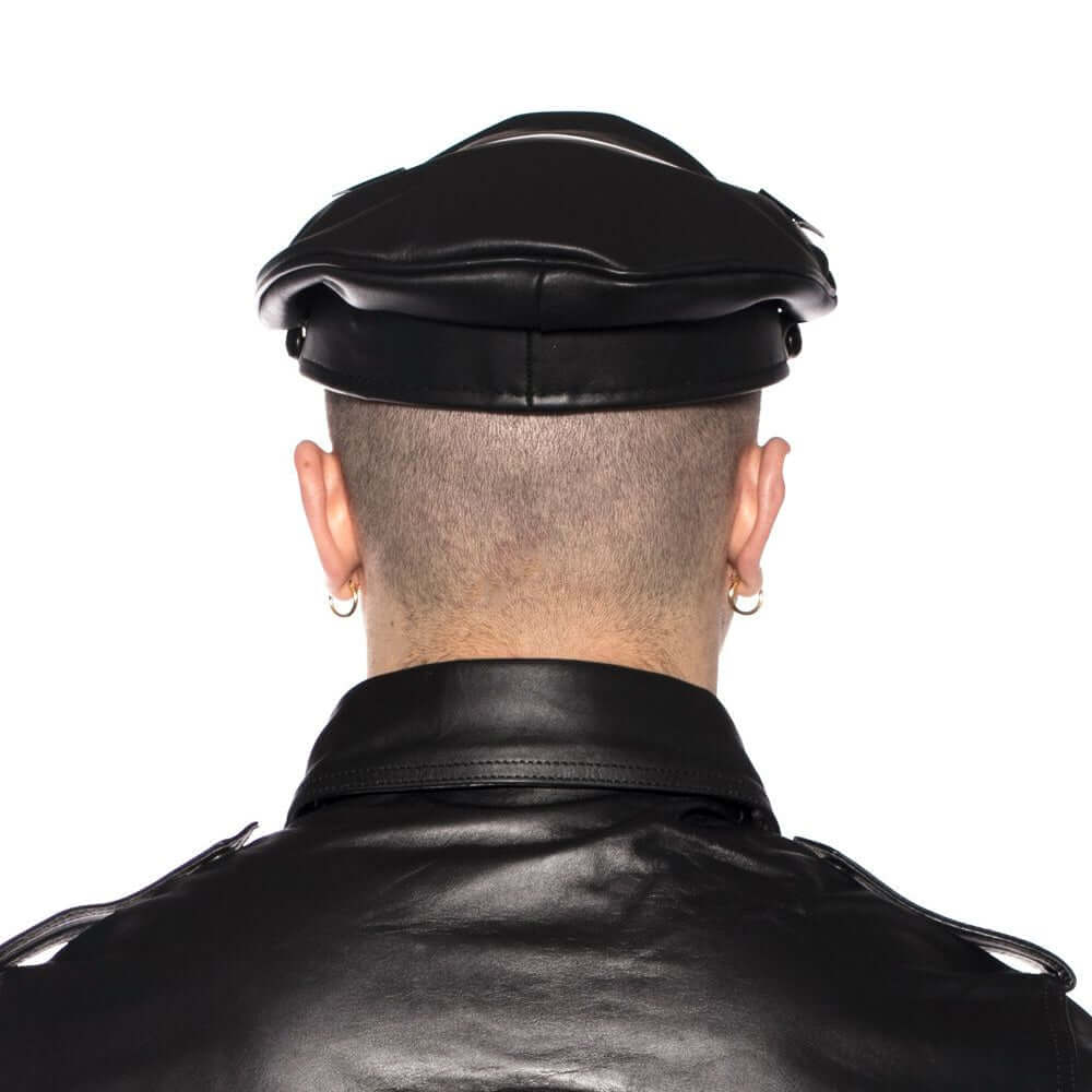 Rear view of a model wearing the Prowler RED Military Cap Black 55cm Small, styled with a leather jacket.