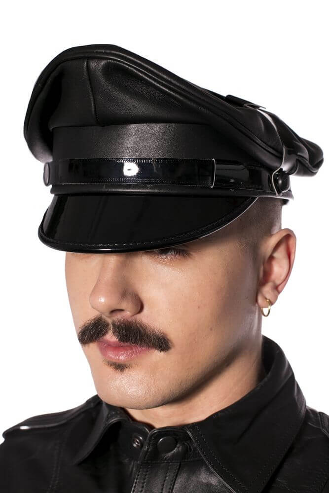 Man wearing Prowler Red Military Cap Black 61cm XL with leather attire and stylish faux police look.