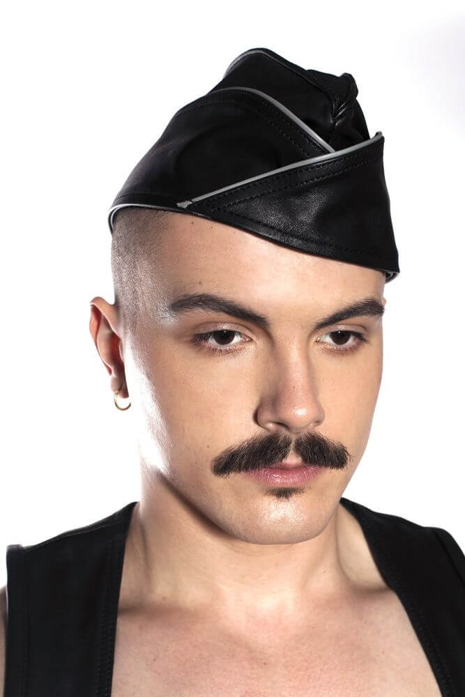 Prowler RED Triangle Cap Grey 59cm Large worn by a model, showcasing its stylish leather design and edgy look.