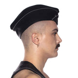 Prowler RED Triangle Cap Grey 59cm Large worn by a model in profile, showcasing its structured design and leather aesthetic.