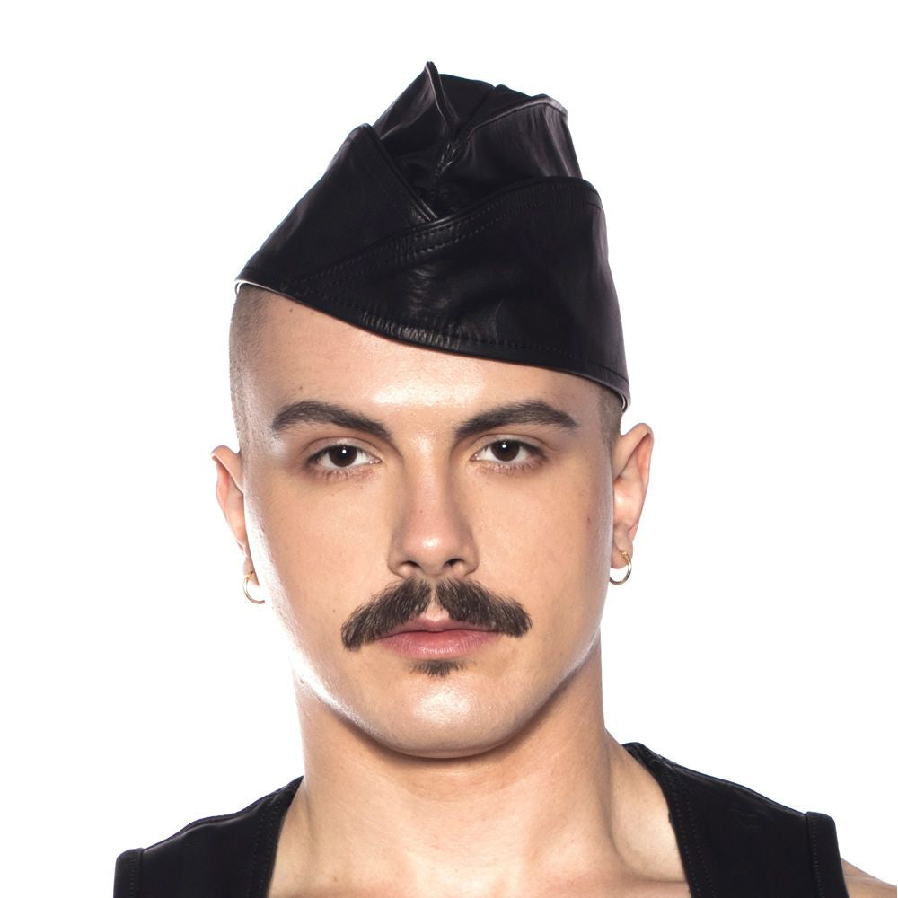 Man wearing Prowler Red Triangle Cap Black 55 cm Small with a stylish leather look.