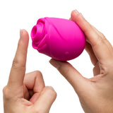 Romp Rose 2.0 Air Suction Stimulator in a hand showcasing its rose-inspired design and sensory features.