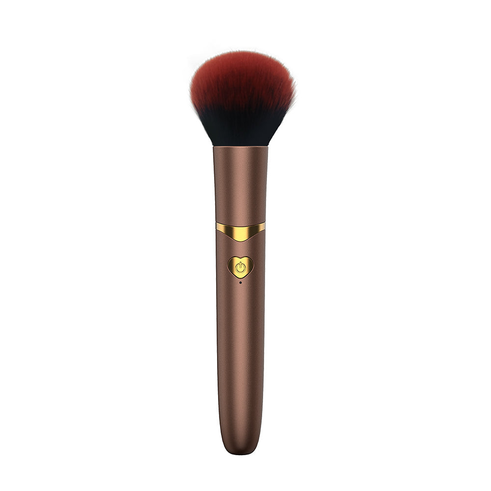The Pleasure Company Brush Vibrating Bullet Gold brush with soft bristles and gold accents, perfect for discreet stimulation.