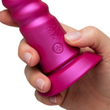 Person holding the Romp Jiggle Thrusting Vibrator Pink featuring a sleek design and suction cup base.