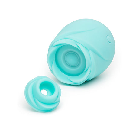 Romp Glow Air Suction Rose Massager in soft blue silicone with removable head for customizable stimulation.