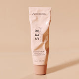 Sex Au Naturel Vulva Balm Soothing Moisturizer tube on a minimalist background