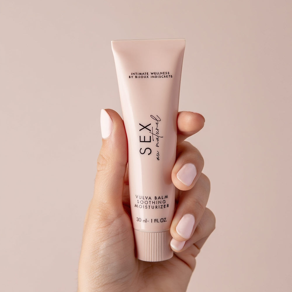 Sex Au Naturel Vulva Balm Soothing Moisturizer in a hand, showcasing its soothing packaging for intimate care.